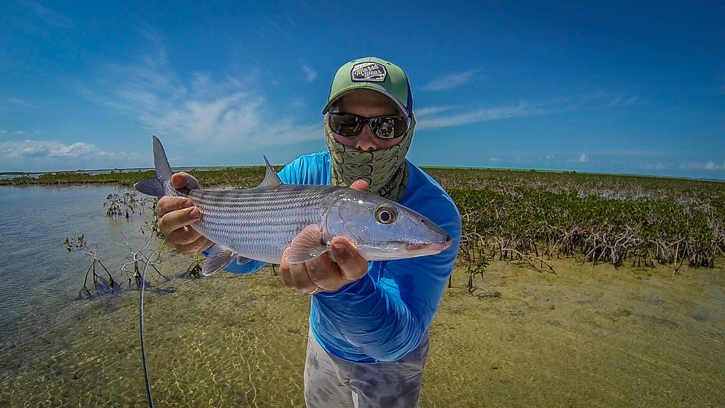 Wading for bonefish in shallow flats with Simms Flats Sneakers — Red's Fly  Shop
